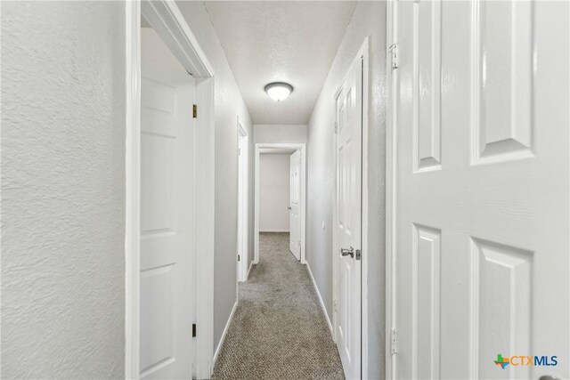 3400 Sally Cir, Kempner, TX 76539 - corridor with carpet floors, baseboards, and a textured wall