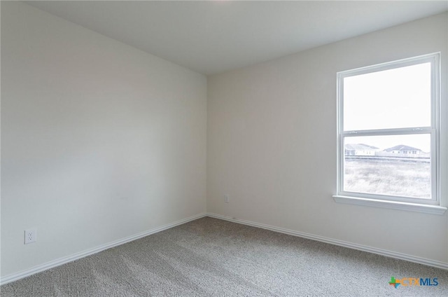 bedroom featuring light colored carpet and multiple windows