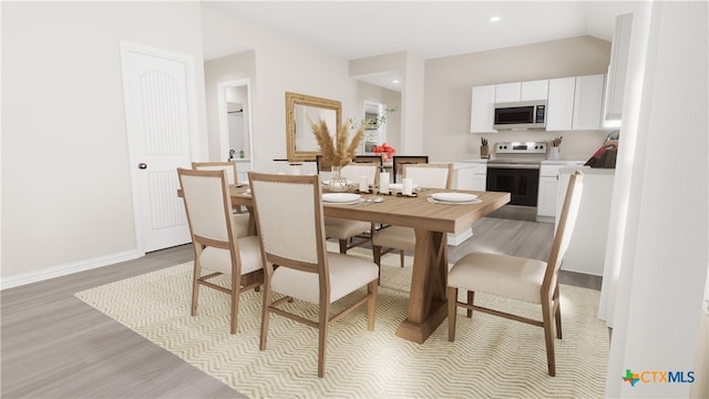 dining space with light hardwood / wood-style flooring