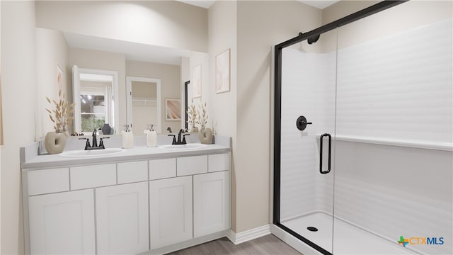 bathroom featuring an enclosed shower, vanity, and hardwood / wood-style flooring