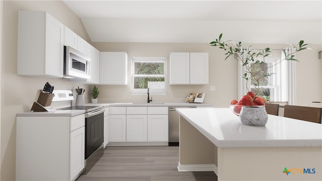 kitchen with white cabinetry, appliances with stainless steel finishes, and light hardwood / wood-style flooring