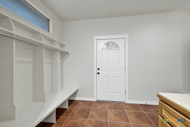 mudroom featuring dark tile patterned floors