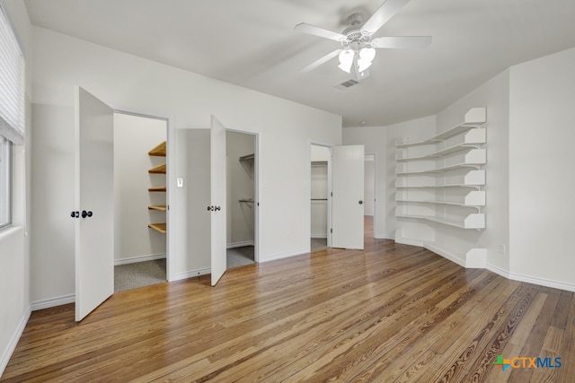 unfurnished bedroom with light wood-type flooring and ceiling fan