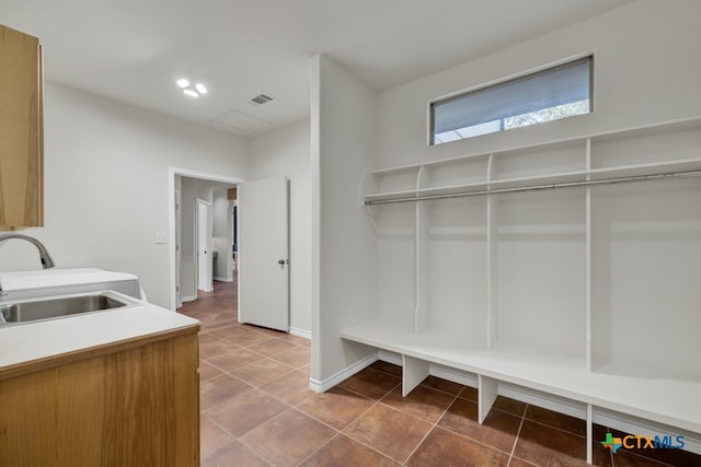 mudroom with sink and tile patterned floors