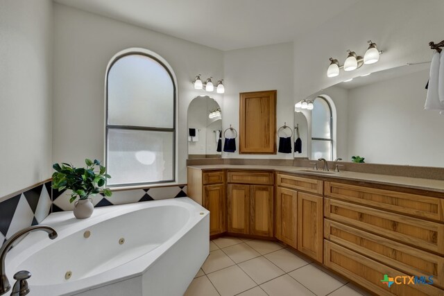 bathroom with vanity, a tub to relax in, and tile patterned floors