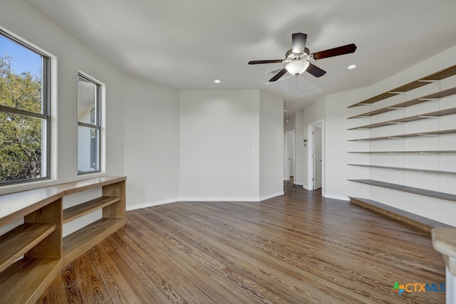 unfurnished living room with hardwood / wood-style flooring and ceiling fan