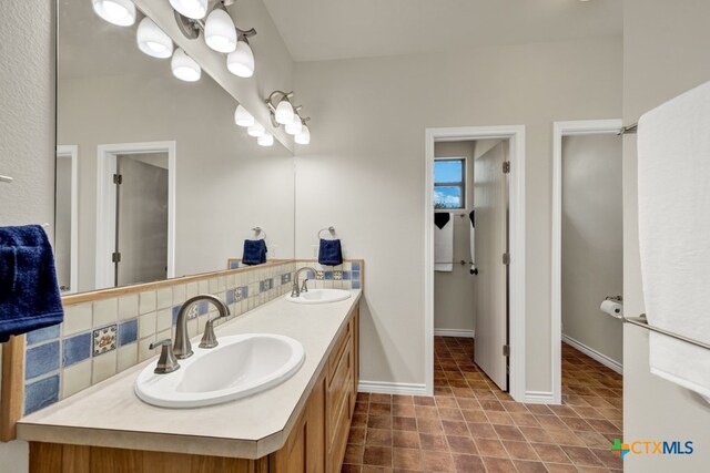 bathroom with vanity and backsplash