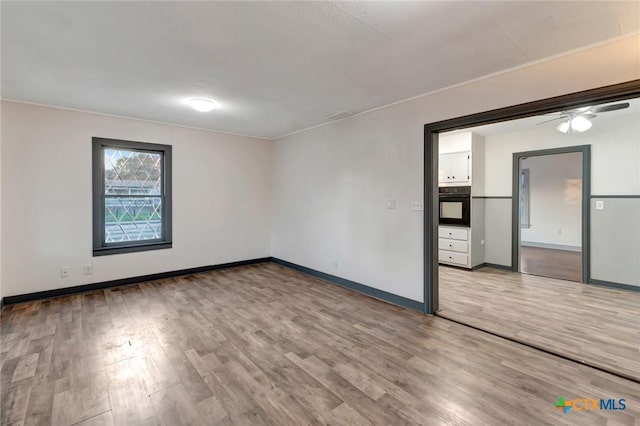 2901 Lone Tree Rd, Victoria, TX 77901 - spare room with light wood-style floors, ornamental molding, and a ceiling fan