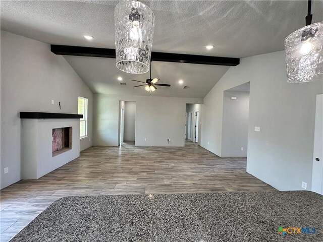 2591 Cedar Glen Dr, Belton, TX 76513 - unfurnished living room featuring a ceiling fan, wood finished floors, a fireplace, and a textured ceiling