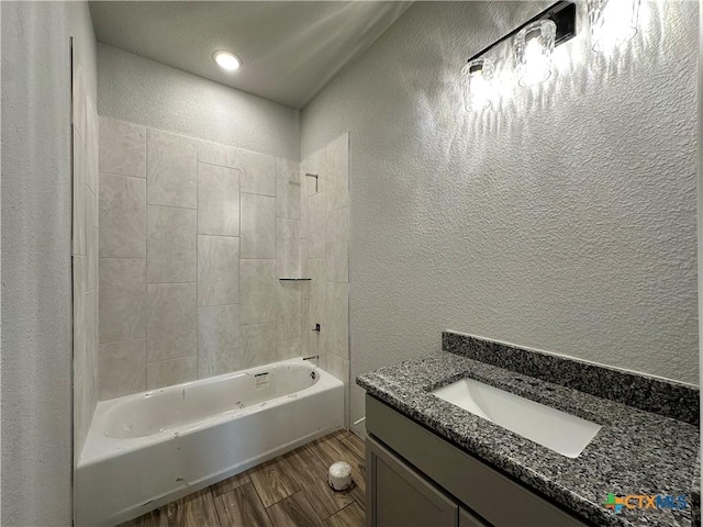 2591 Cedar Glen Dr, Belton, TX 76513 - bathroom featuring a textured wall, vanity, wood finished floors, and shower / washtub combination