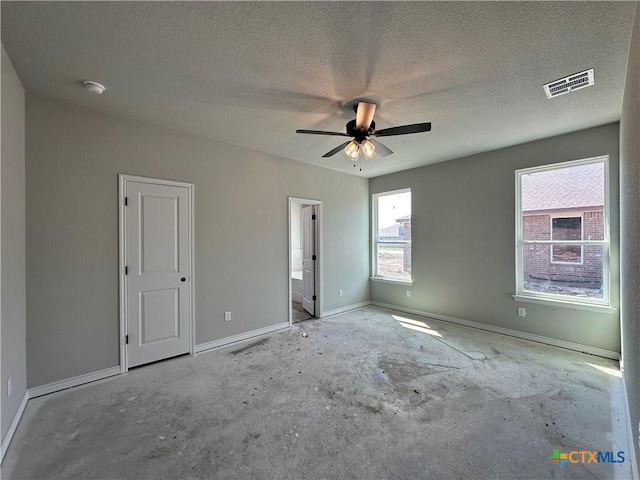 2591 Cedar Glen Dr, Belton, TX 76513 - unfurnished bedroom featuring a textured ceiling, unfinished concrete floors, baseboards, ceiling fan, and ensuite bathroom