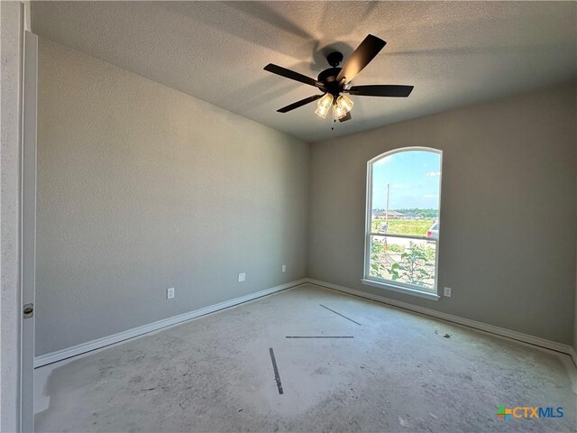 2591 Cedar Glen Dr, Belton, TX 76513 - empty room featuring unfinished concrete floors, ceiling fan, baseboards, and a textured ceiling