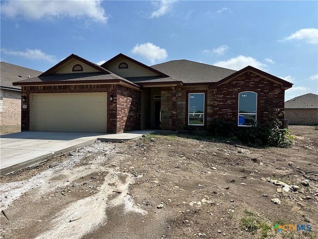 2591 Cedar Glen Dr, Belton, TX 76513 - view of front of house with a garage, brick siding, concrete driveway, and a shingled roof