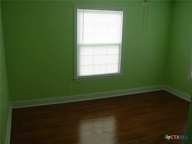 unfurnished room featuring dark hardwood / wood-style flooring