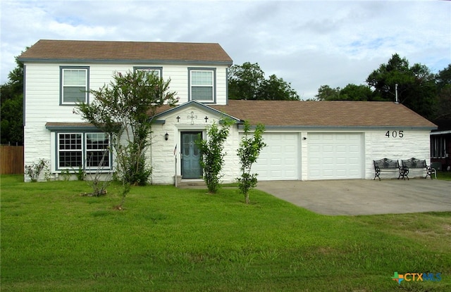 view of front of property with a front yard and a garage