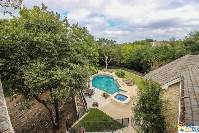 view of swimming pool with an in ground hot tub and a patio