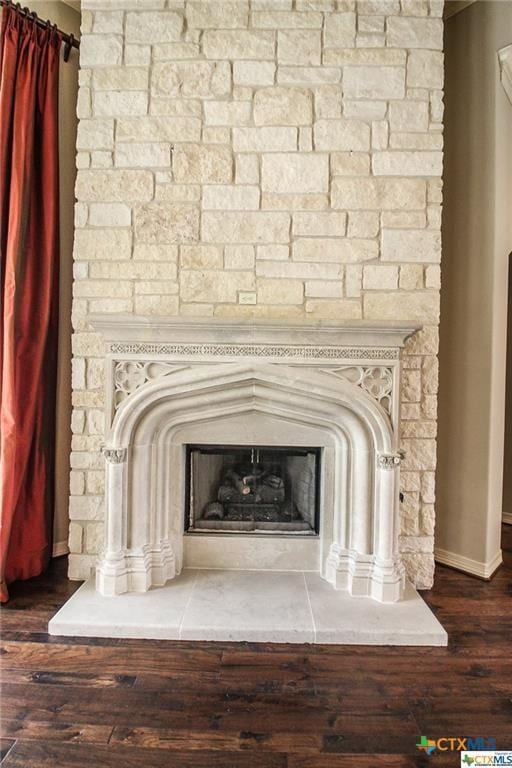 details featuring hardwood / wood-style floors and a fireplace