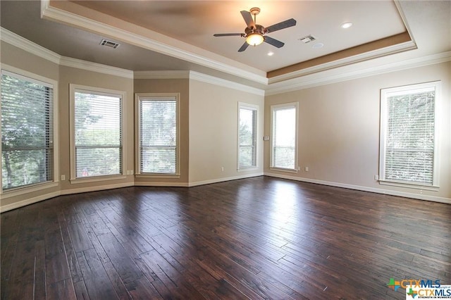 unfurnished room with a wealth of natural light, crown molding, and dark hardwood / wood-style floors