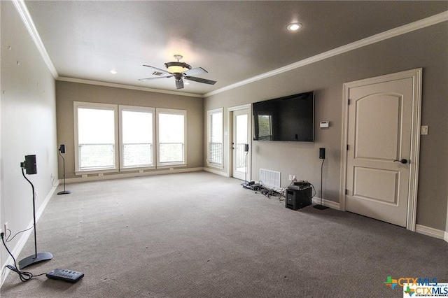 unfurnished living room featuring ceiling fan, light colored carpet, and ornamental molding