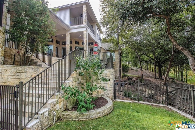 exterior space with a balcony and a yard