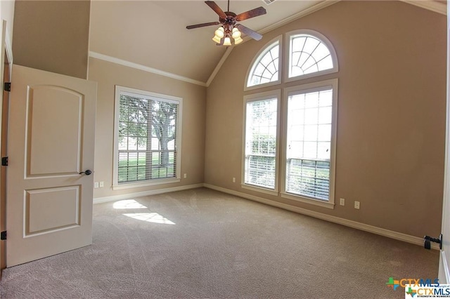 carpeted empty room with high vaulted ceiling, ceiling fan, and ornamental molding