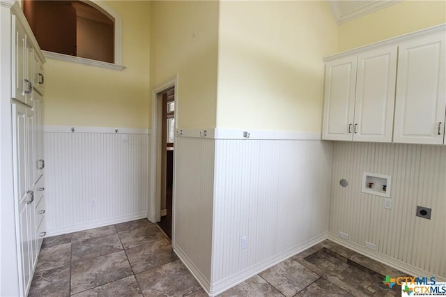 clothes washing area with ornamental molding, hookup for a washing machine, cabinets, and hookup for an electric dryer