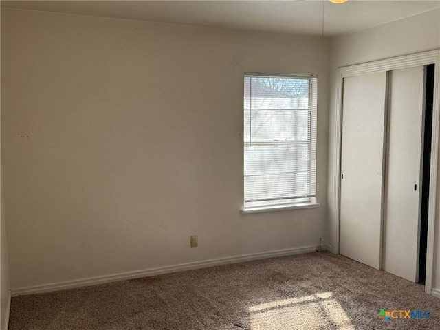 unfurnished bedroom featuring a closet and carpet