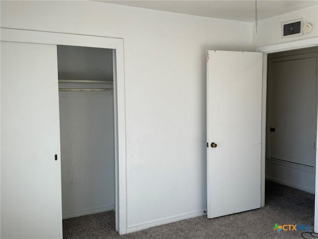 unfurnished bedroom with a closet and carpet