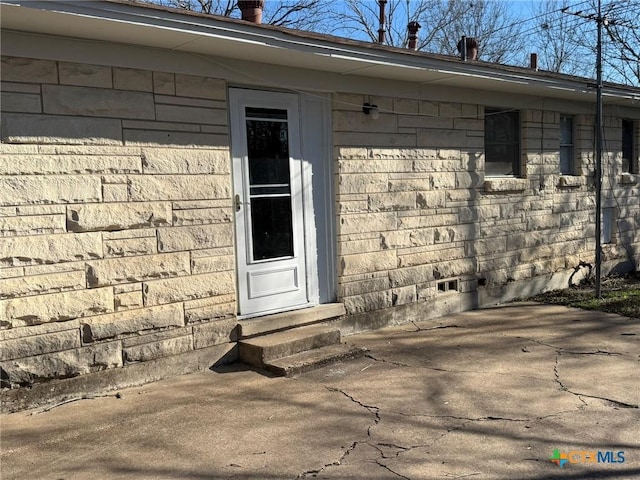 entrance to property with a patio