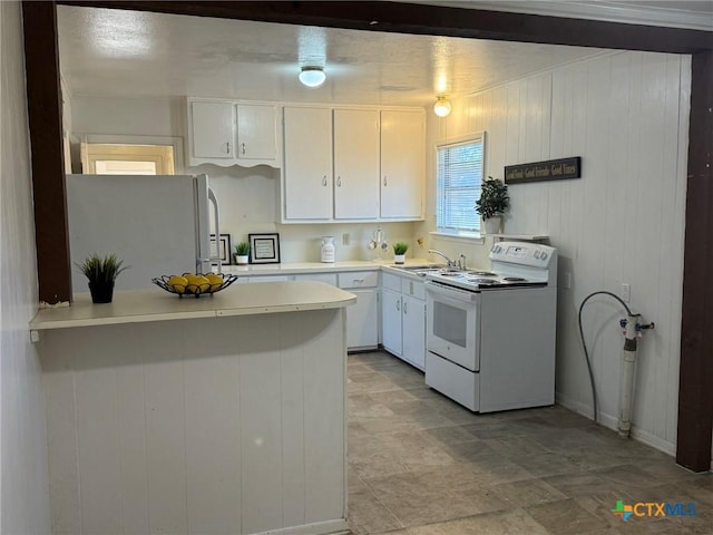 kitchen featuring white cabinetry, white appliances, kitchen peninsula, and sink