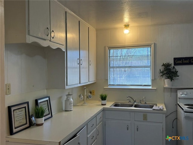 kitchen with white range with electric cooktop and sink