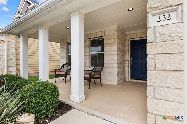 232 Gaida Loop, Georgetown, TX 78628 - doorway to property with a porch and stone siding