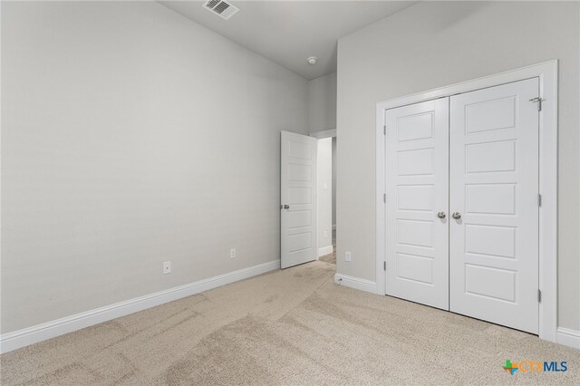 232 Gaida Loop, Georgetown, TX 78628 - unfurnished bedroom with carpet, baseboards, a closet, and lofted ceiling