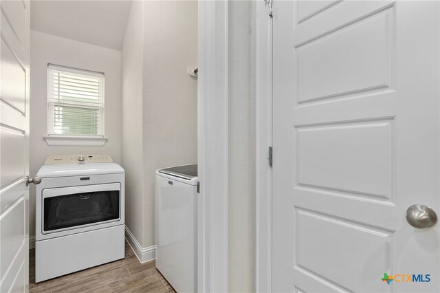 232 Gaida Loop, Georgetown, TX 78628 - laundry room featuring washer and dryer, light wood-type flooring, and baseboards