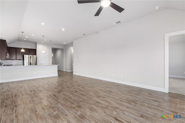 232 Gaida Loop, Georgetown, TX 78628 - unfurnished living room with lofted ceiling, light wood-style flooring, a ceiling fan, recessed lighting, and baseboards