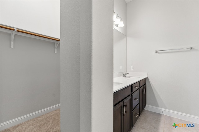 232 Gaida Loop, Georgetown, TX 78628 - bathroom with double vanity, baseboards, and a spacious closet