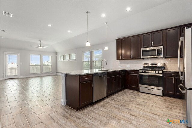 232 Gaida Loop, Georgetown, TX 78628 - kitchen featuring stainless steel appliances, a sink, plenty of natural light, a peninsula, and vaulted ceiling