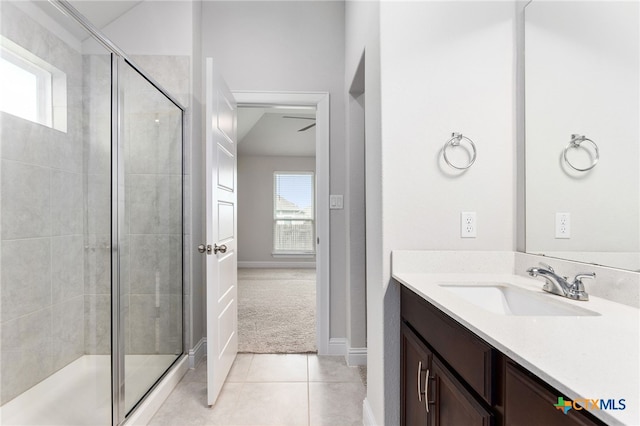 232 Gaida Loop, Georgetown, TX 78628 - bathroom featuring vanity, a stall shower, tile patterned flooring, and baseboards