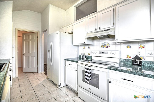 kitchen featuring under cabinet range hood, white appliances, white cabinets, light tile patterned floors, and decorative backsplash