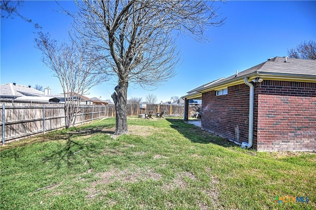 view of yard with a fenced backyard