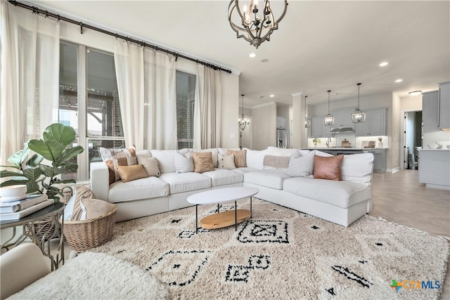 living room featuring light tile patterned floors and an inviting chandelier