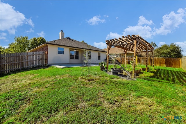 rear view of house featuring a patio area, a pergola, and a yard