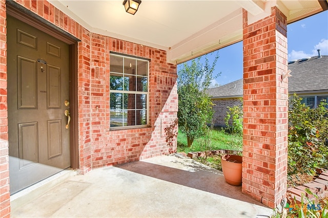 view of exterior entry with a porch