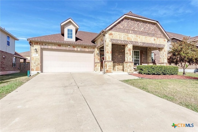 view of front of home with covered porch, a garage, and a front lawn