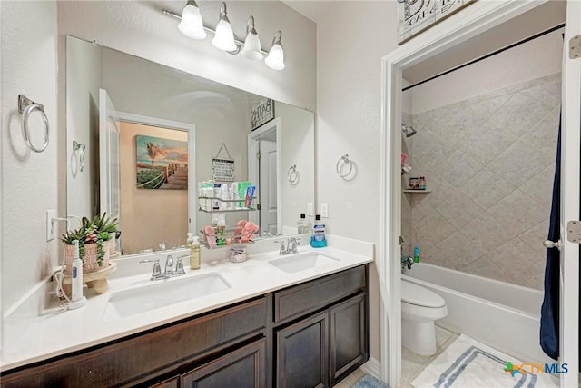 full bathroom featuring tile patterned floors, vanity, toilet, and tiled shower / bath