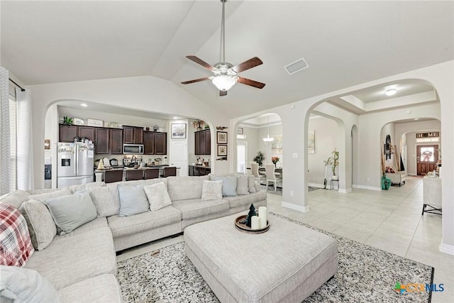 living room featuring light tile patterned floors, vaulted ceiling, and ceiling fan