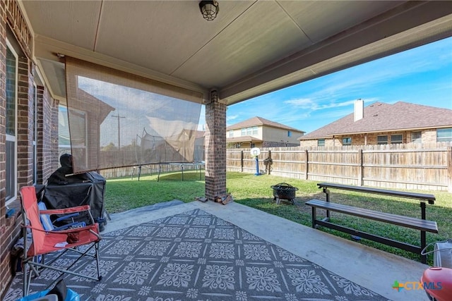 view of patio featuring a trampoline and grilling area