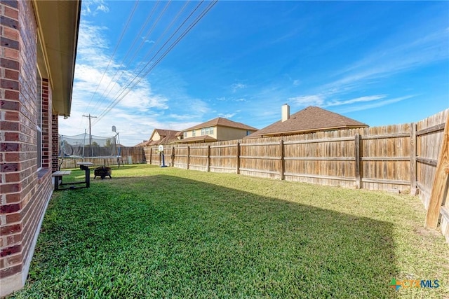 view of yard with a trampoline