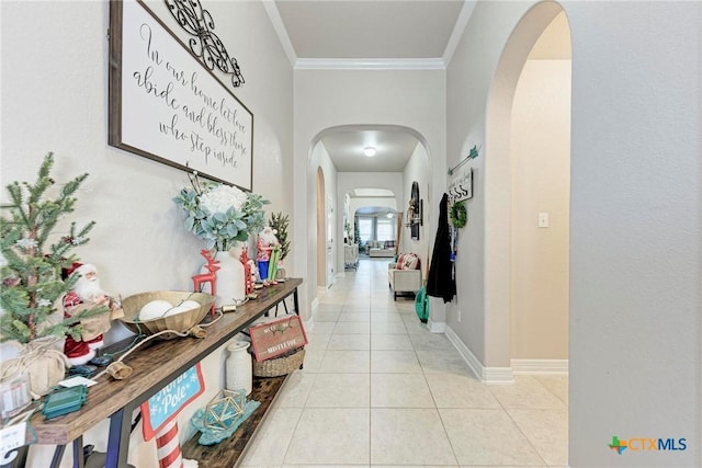 hall with light tile patterned flooring and ornamental molding