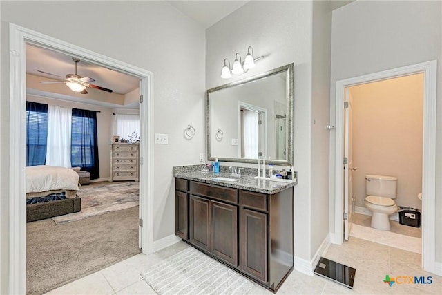 bathroom featuring ceiling fan, tile patterned flooring, vanity, and toilet